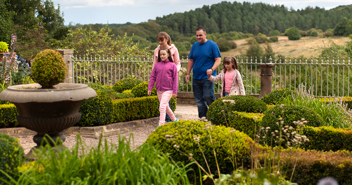 Family walking through a garden at Beamish Museum